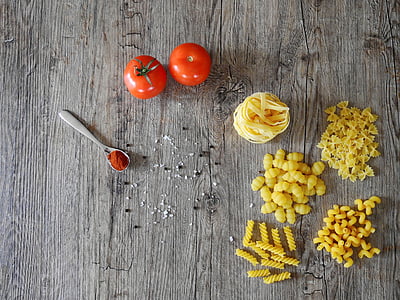 pastas and tomato on wooden surface thumbnail
