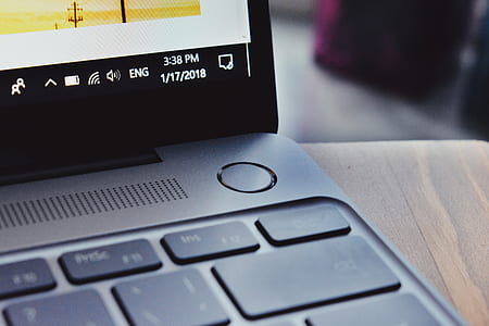 gray and black laptop computer on brown wooden surface thumbnail