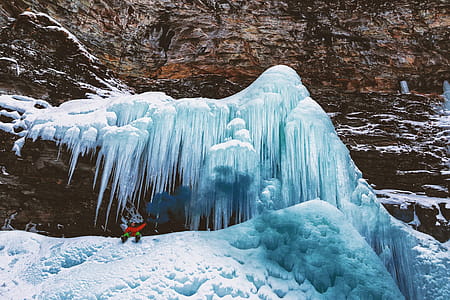 Person Sits on Mountain With Icicles thumbnail