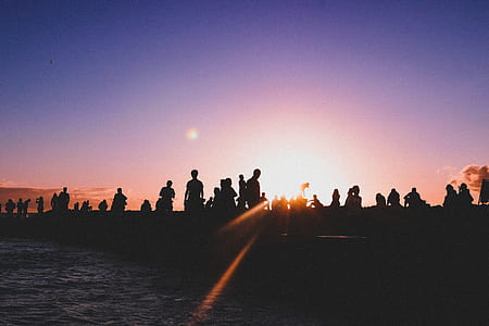 silhouette of people standing beside water thumbnail