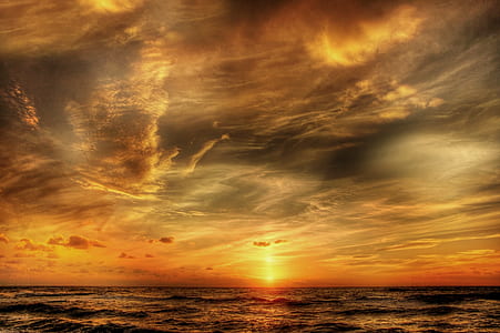 sunset on beach under white clouds thumbnail
