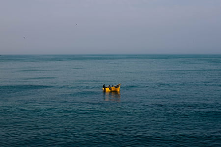 yellow sailboat on body of water thumbnail