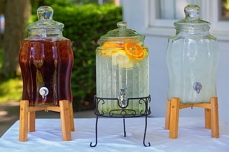 three clear beverage dispensers on top of table thumbnail