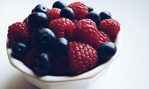 raspberries on white ceramic bowl thumbnail