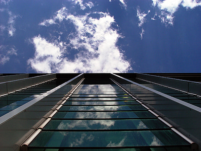 worms eye view photography of building under cloudy sky thumbnail