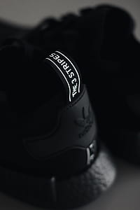 closeup photo of black adidas The 3 Stripe sneaker thumbnail
