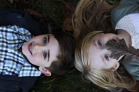 girl and boy lying on ground thumbnail