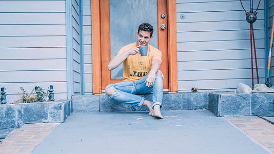 man sitting on gray stone door step thumbnail