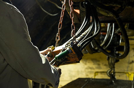 person holding black cables and chain thumbnail