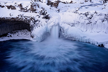 flowing river near snow field thumbnail