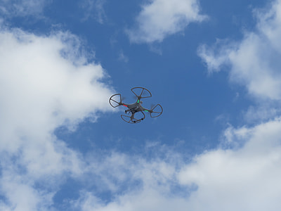 flying gray drone under blue sky at daytme thumbnail