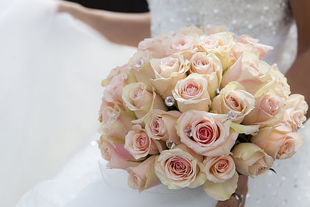 woman wearing white wedding dress carrying pink rose flower bouquet thumbnail