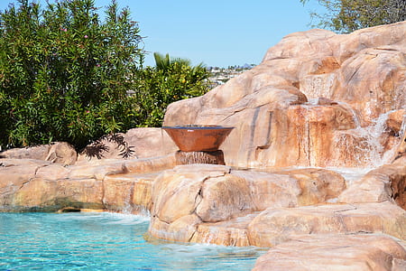 body of water beside rock formation thumbnail