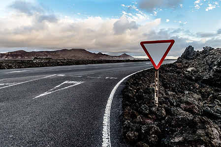 red and white road signage near road thumbnail