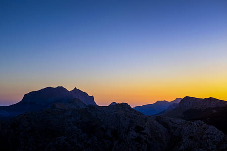 silhouette of mountains during daytime thumbnail