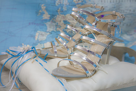 closeup photo of heeled sandals on pillow thumbnail