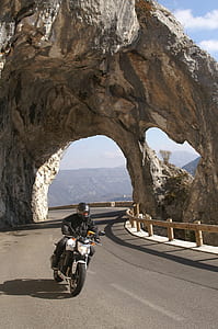 man riding on white and black motorcycle thumbnail