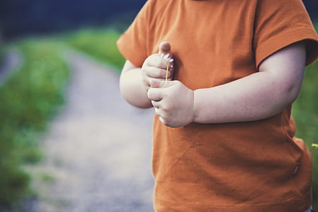 boy holding white flower thumbnail