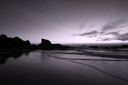 grayscale photo of body of water under cloudy sky thumbnail