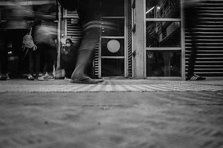 grayscale photo of people walking on concrete pavement thumbnail