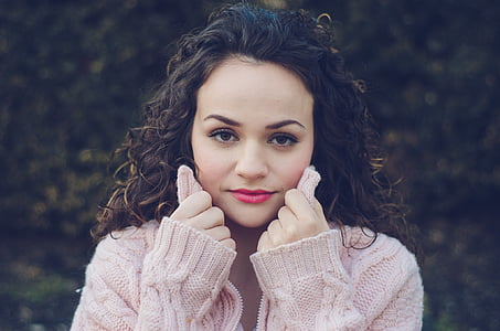 woman wearing pink cable-knit sweater thumbnail