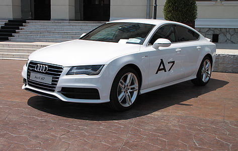white Audi A7 sedan parked in front of white building thumbnail