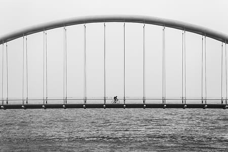 person cycling on bridge thumbnail