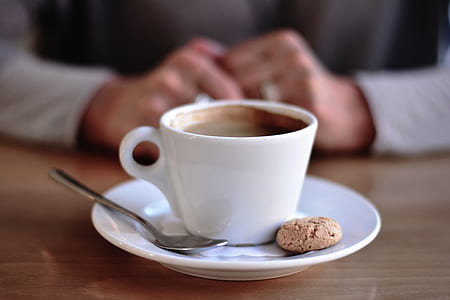 white teacup filled with liquid on saucer beside cookie thumbnail