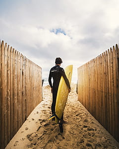 man holding surboard thumbnail