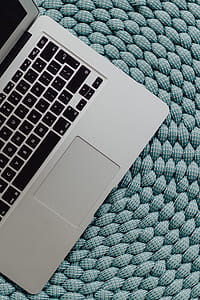 MacBook Laptop on a blue pouf thumbnail