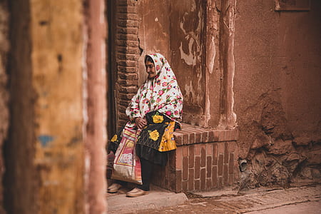 woman sitting on brown brick surface thumbnail