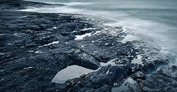 photo of rocks near body of water thumbnail