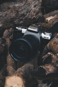 black and gray Pentax MZ-50 camera on brown firewood thumbnail