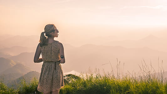 woman wearing brown sleeveless top standing on grass filed thumbnail