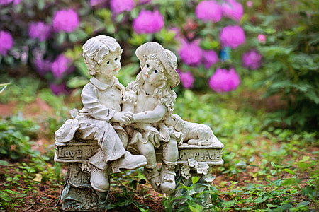 two white concrete toddlers sitting on bench figurine thumbnail