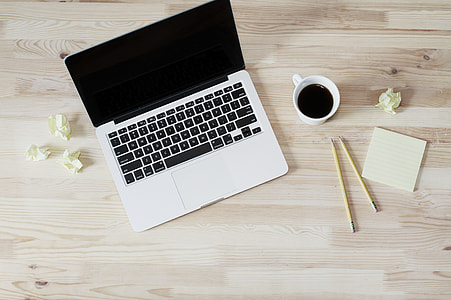 Macbook Pro beside white ceramic mug and two pencils thumbnail