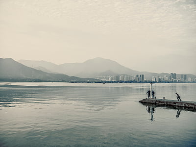 three person standing on concrete dock during daytime thumbnail