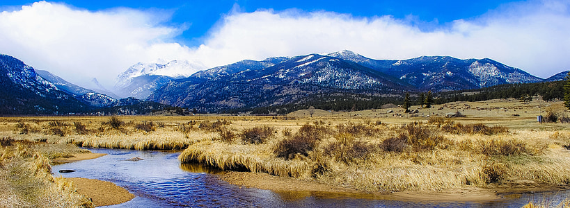landscape photography of mountains under cloudy sky thumbnail