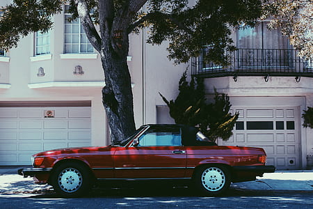 red coupe parked on road near tree thumbnail