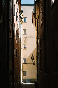 black steel street lantern in middle of street alley thumbnail
