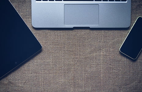 gray laptop on brown surface thumbnail