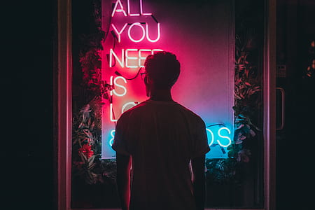 low-light photo of man facing quotation neon sign thumbnail