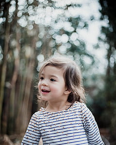 girl near green leafed trees thumbnail
