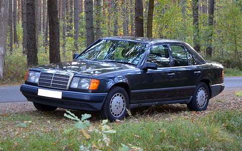 black Mercedes-Benz sedan parked beside road during daytime thumbnail