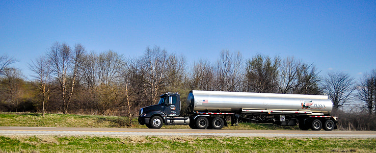 gray and black tanker truck traveling on road at daytime thumbnail