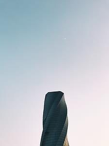 gray spiral building under blue sky during daytime thumbnail