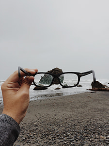 person holding black framed eyeglasses thumbnail