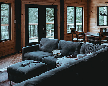 laptop computer on sectional sofa in home thumbnail