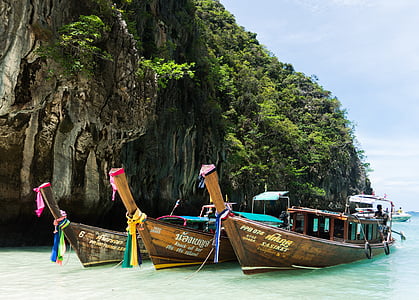 three brown wooden canoes boats thumbnail