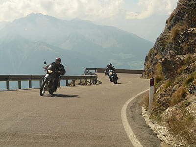 two person riding black motorcycle on road during daytime thumbnail